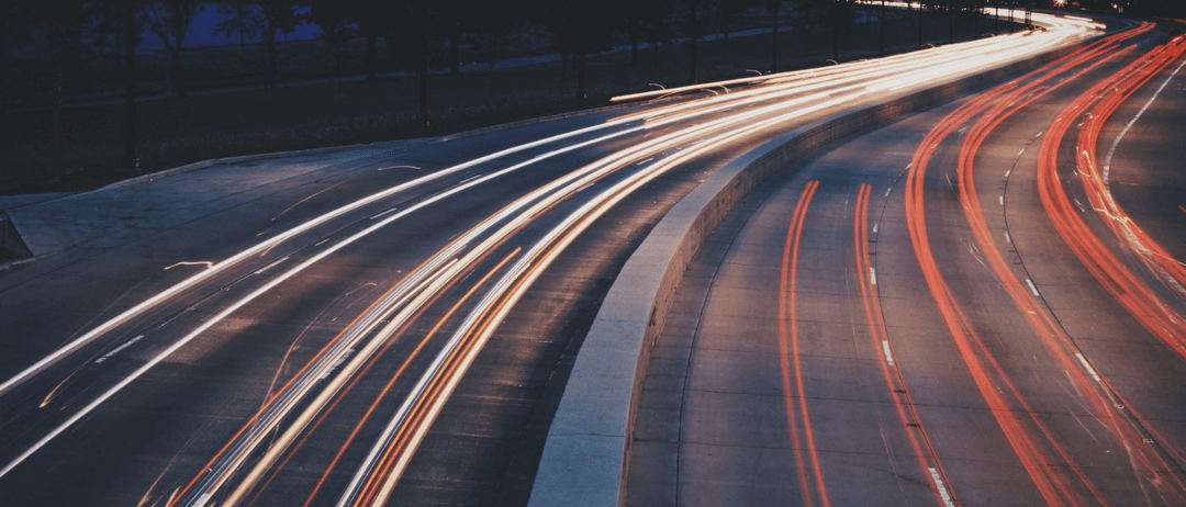 Road with car headlights blurred and extended due to long exposure